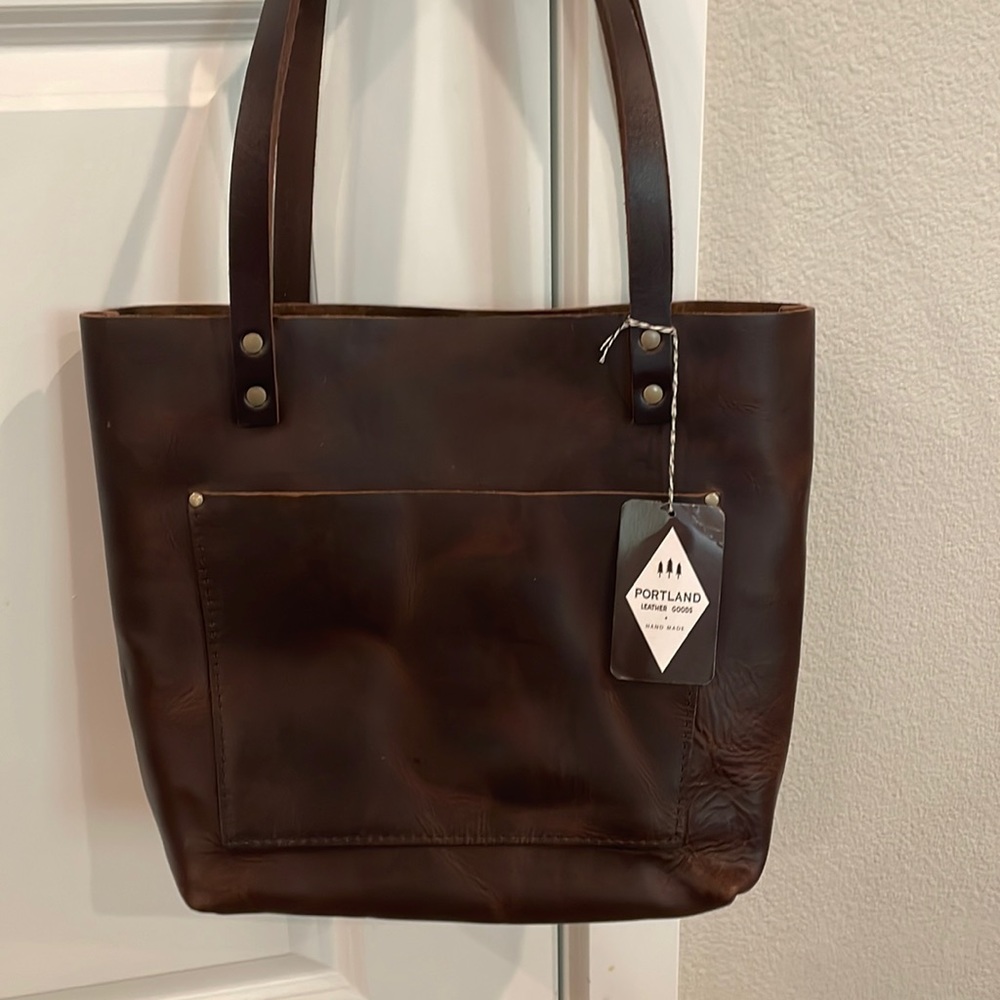 Portland Leather Handbag. Dark brown with a front pocket.